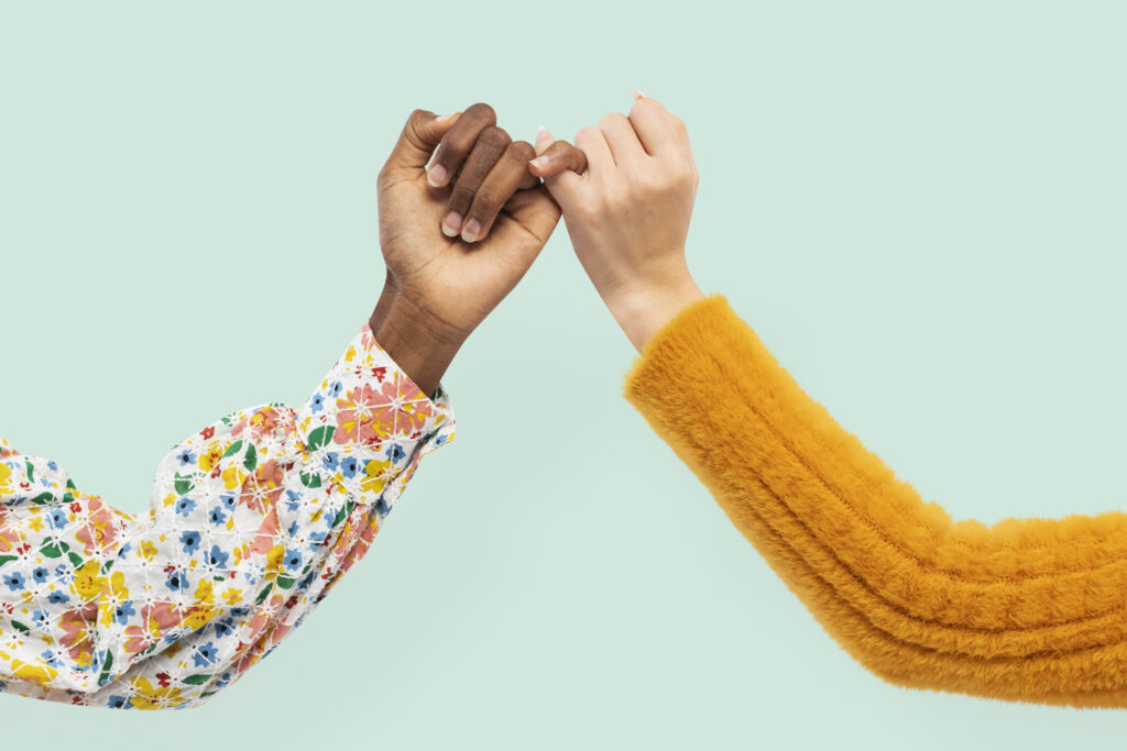 Two hands holding each other