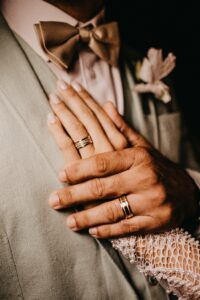 Two hands wearing rings