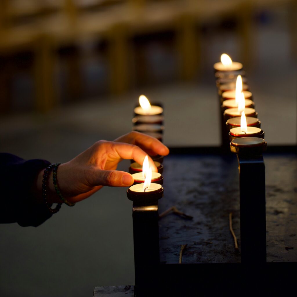 Hand lighting a candle
