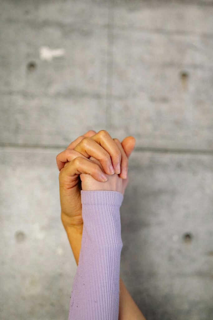 Two hands holding each other